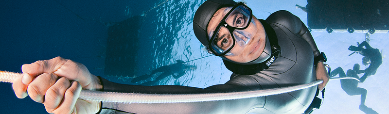 A striking image of a free diver preparing for a dive