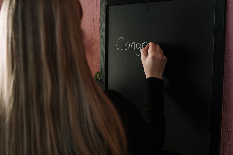 Woman writing on a blackboard