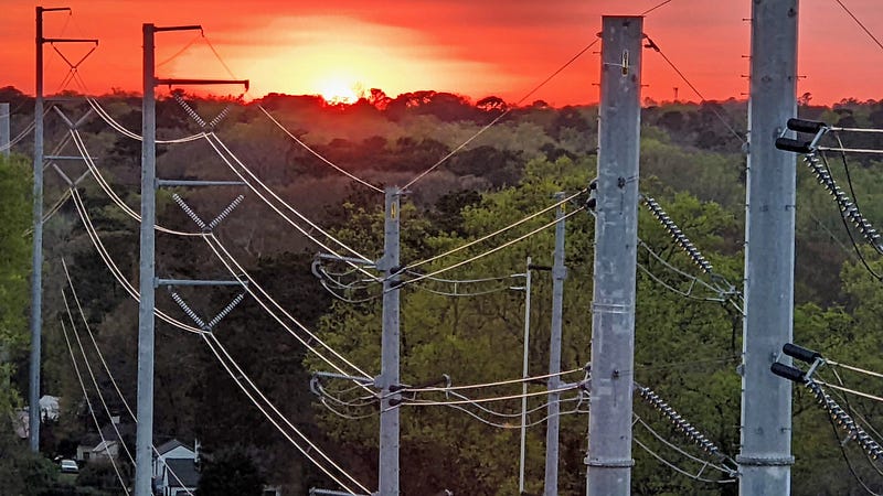 Power lines crossing a city landscape